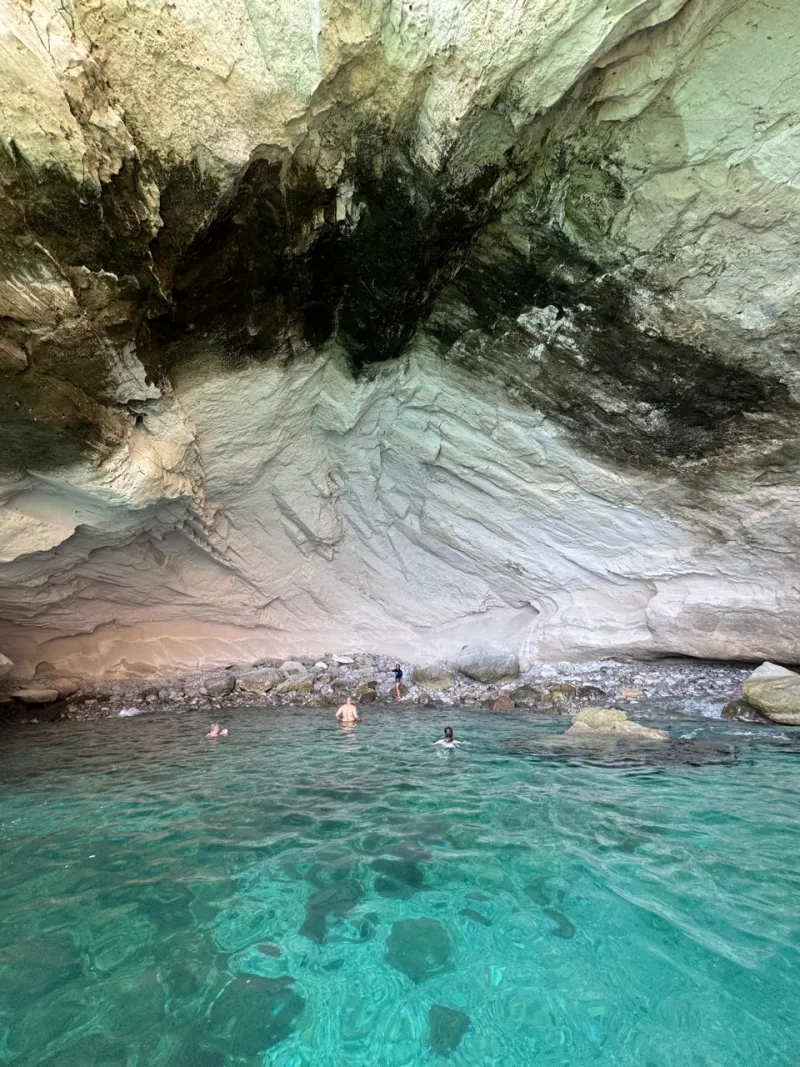 Swimmers in the clear water of a cove