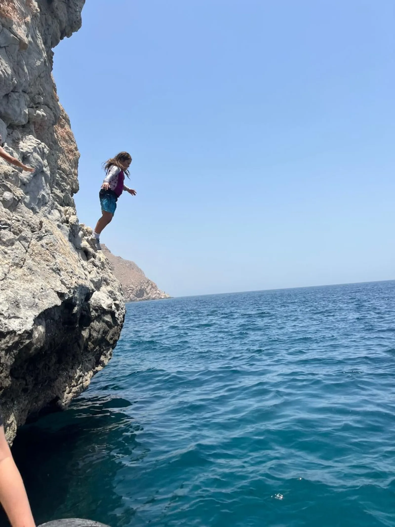 Jumping from the cliff into the sea, deep water solo